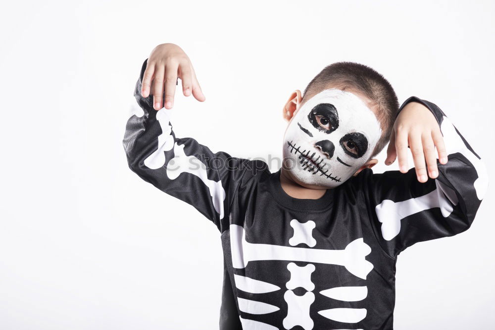 Little kid in a skeleton costume on Halloween Carnival