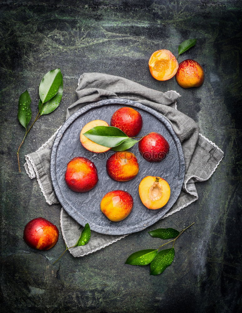 Similar – Image, Stock Photo Fresh peaches with green leaves on stone slab