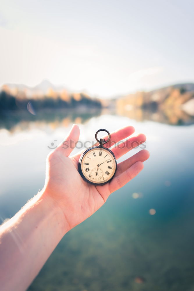 Similar – Image, Stock Photo Hand with compass at mountain road at blue sky