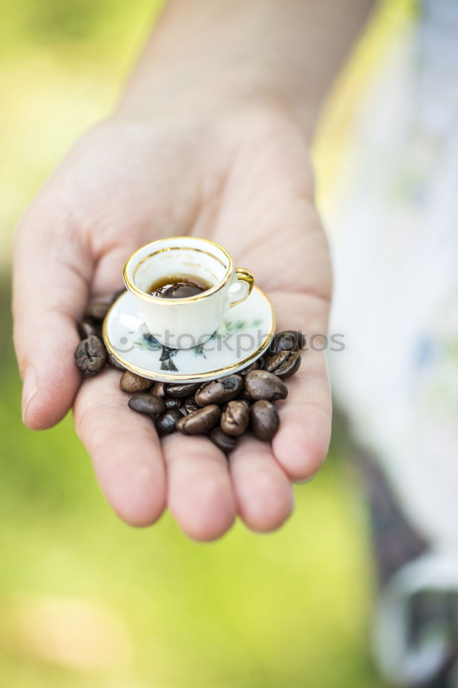 Similar – Image, Stock Photo Hand hold very small cup of coffee