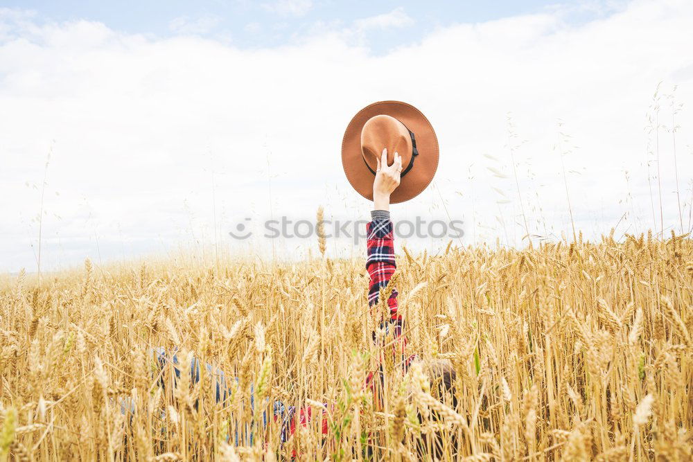 Young cowgirl in a field of cereals