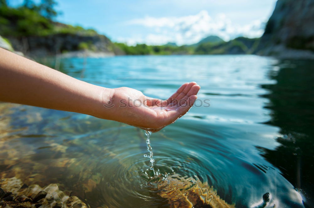 Similar – Image, Stock Photo Young boy taking pure water from a river in the hands