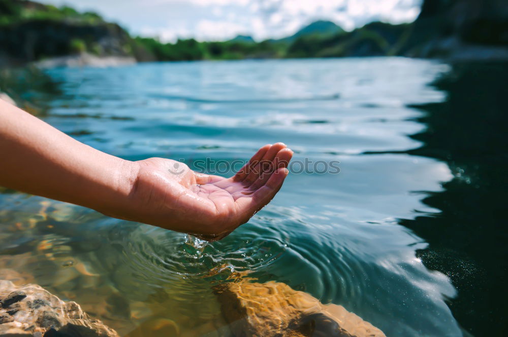 Similar – Image, Stock Photo Young boy taking pure water from a river in the hands