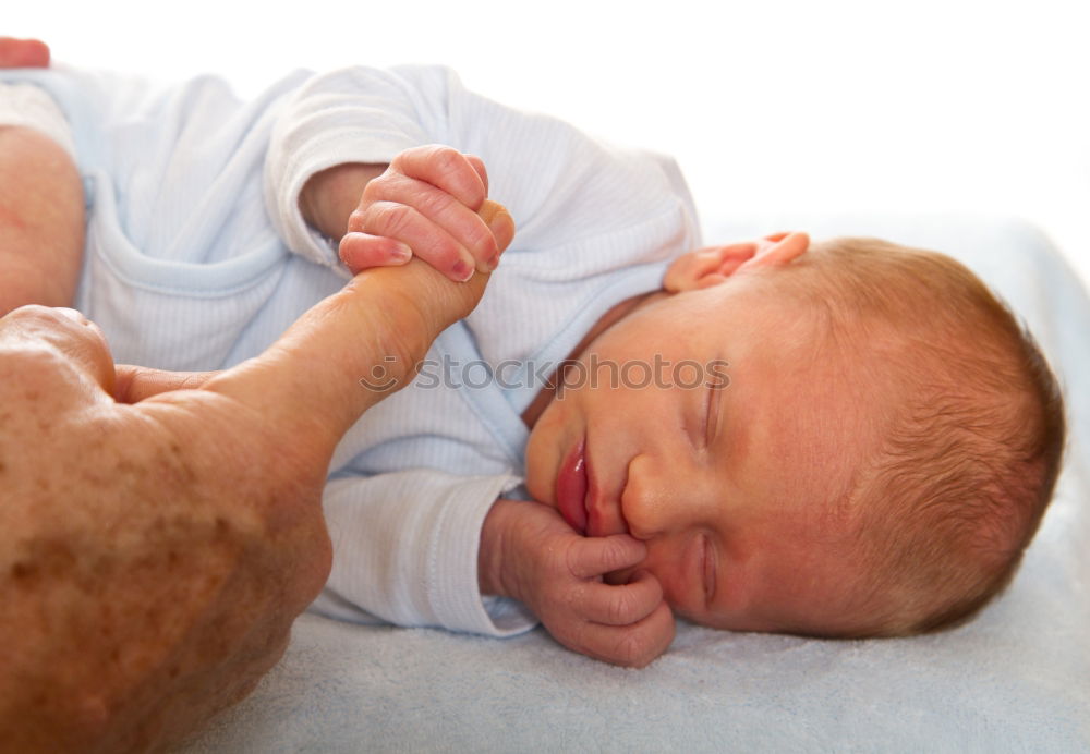 Similar – baby sleeping on his mother’s shoulder