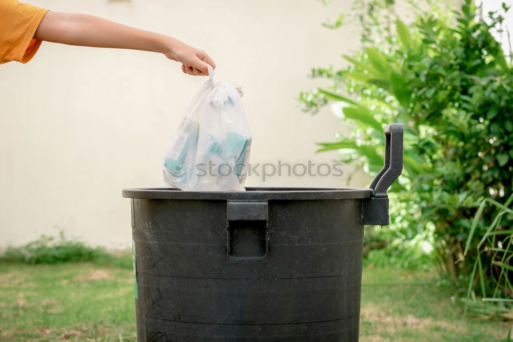 Child play with boat in a bucket of water