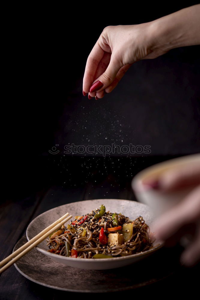 Similar – Foto Bild Eine Person sitzt mit Essstäbchen in der Hand vor einer leckeren Pho Suppe in Vietnam