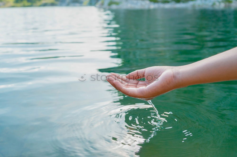 Similar – Image, Stock Photo Young boy taking pure water from a river in the hands