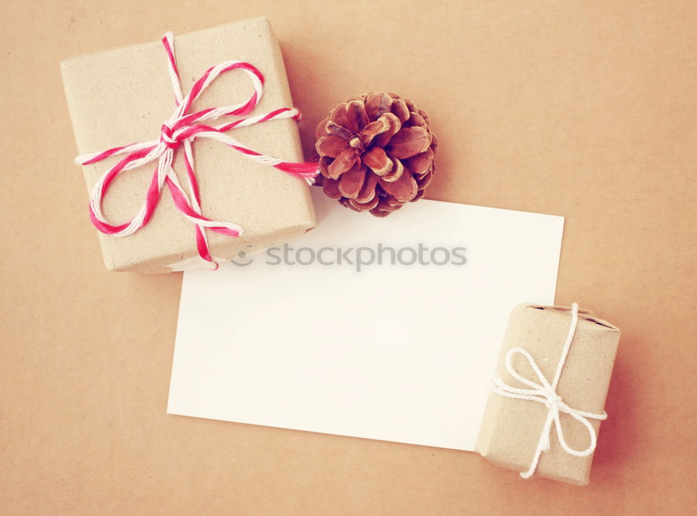 Similar – Gift box wrapped in recycled paper, red bow and tag