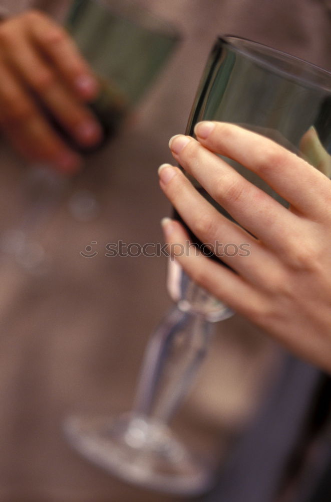 Similar – On a table there is a bottle of alcohol and a shot glass. A person’s hand is holding the shot glass.