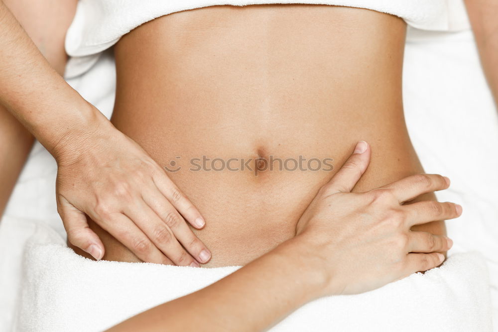 Similar – Hands massaging female abdomen.