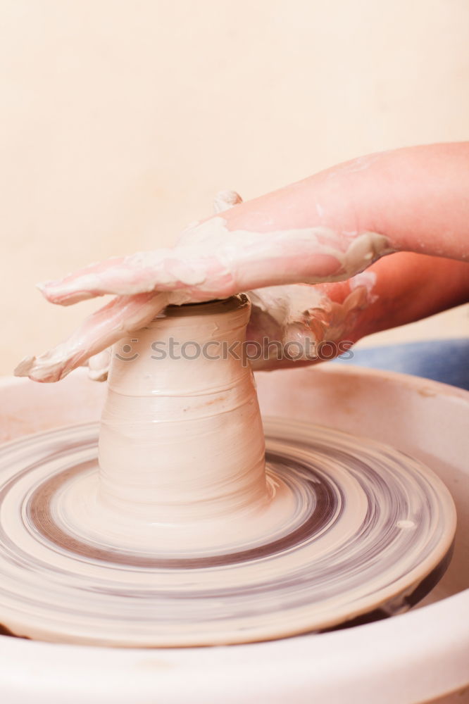 Similar – Image, Stock Photo Young female sitting by table and making clay or ceramic