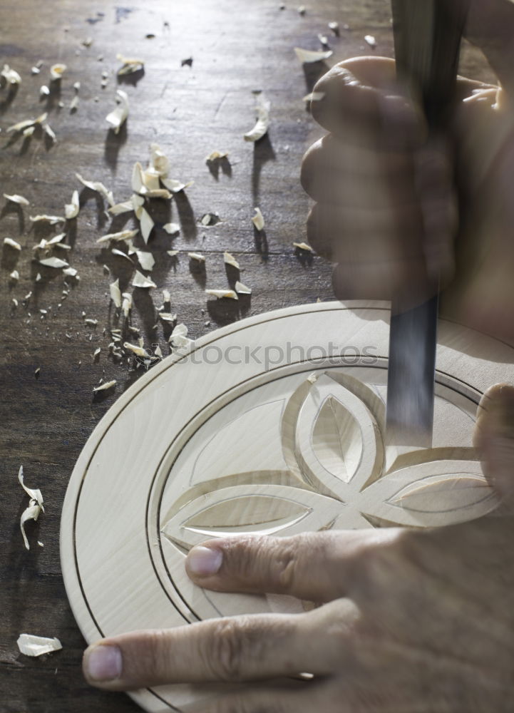 Similar – Hands of woodcarver make wooden bowl