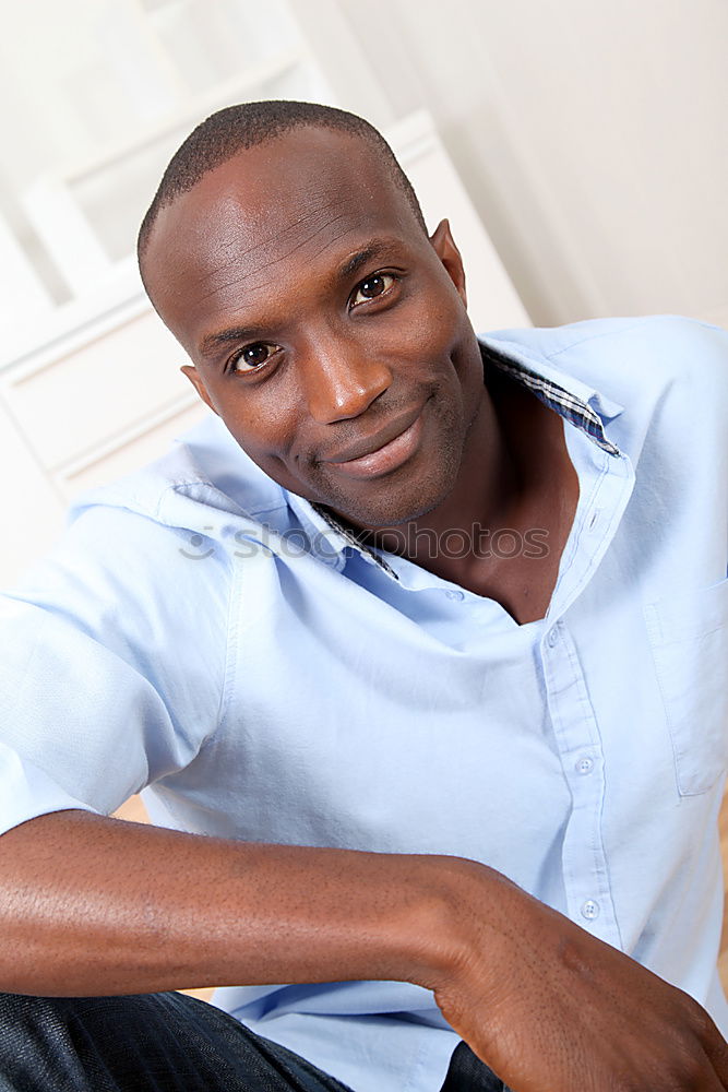 Similar – Black young man with arms crossed smiling in urban background