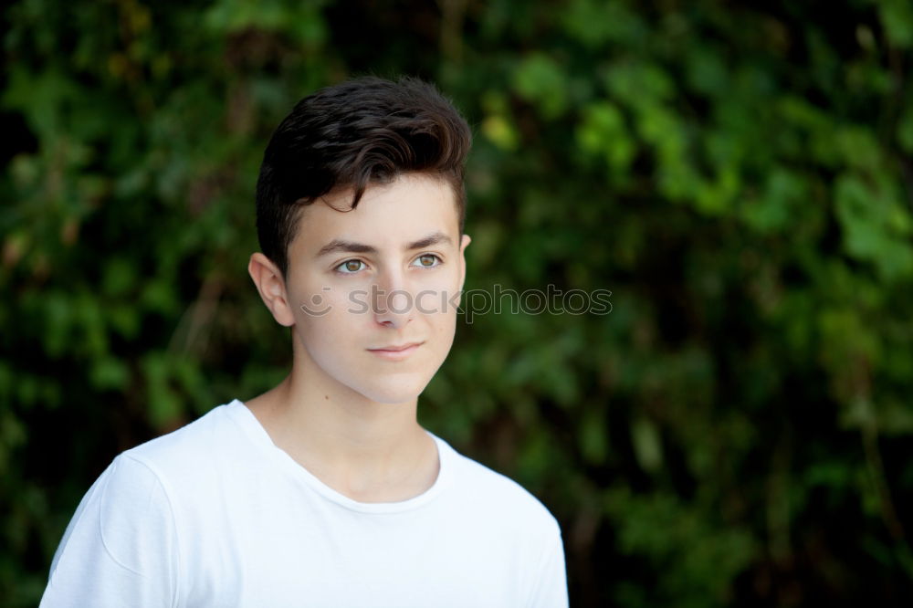 Attractive teenager guy in a park