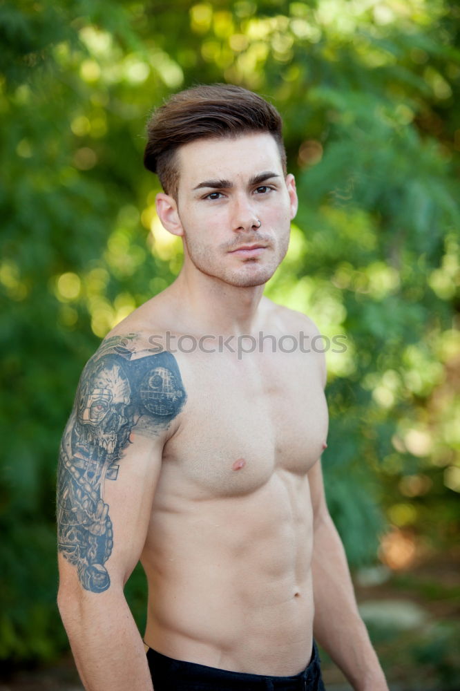 Similar – shirtless muscular man showing abs