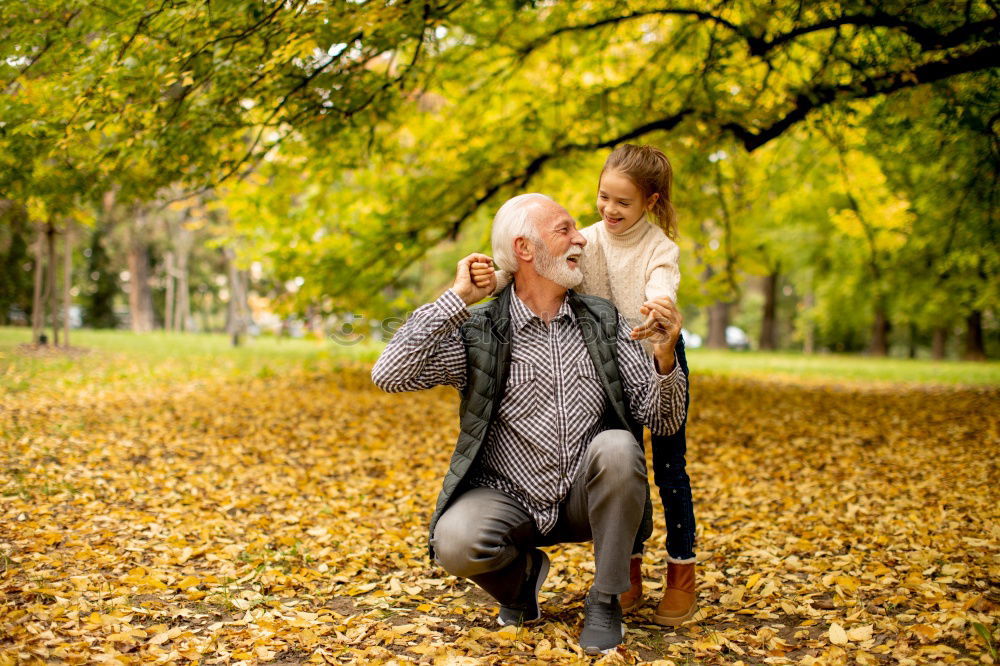 Similar – Couple makes a leaf fight in autumn