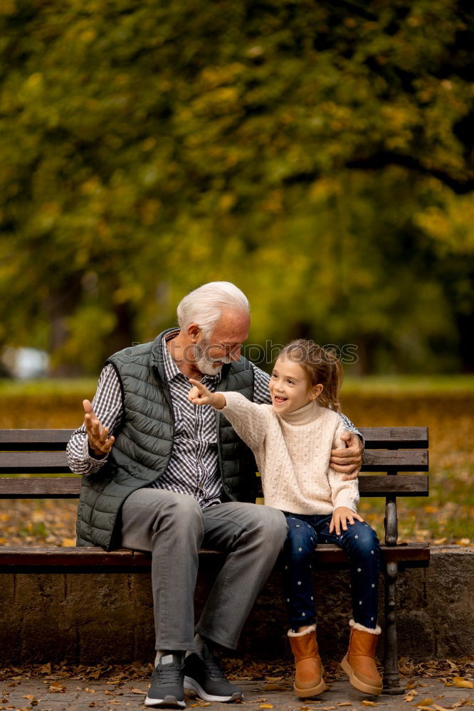 Similar – Grandfather With His grandson on the lake. Back view