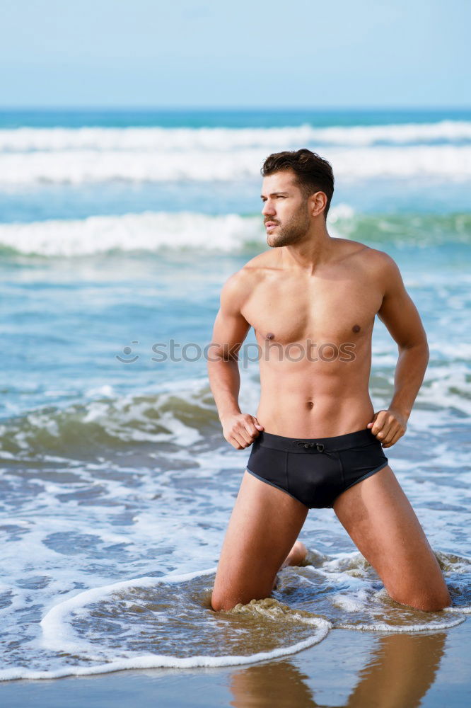 Similar – Handsome man on his knees on the sand of the beach