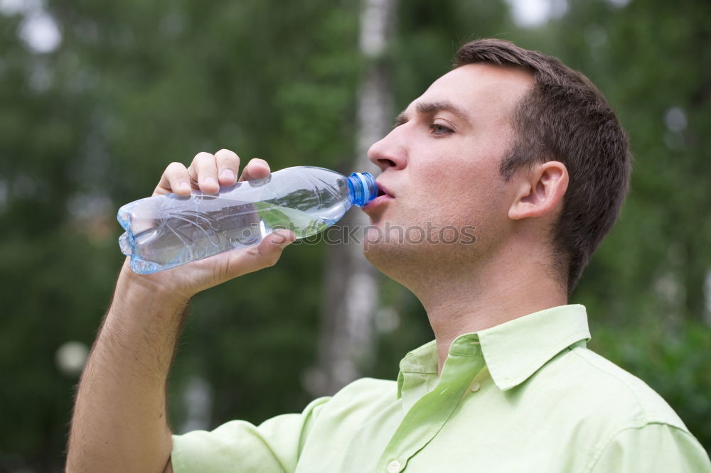 Similar – Fit young woman drinking bottled water