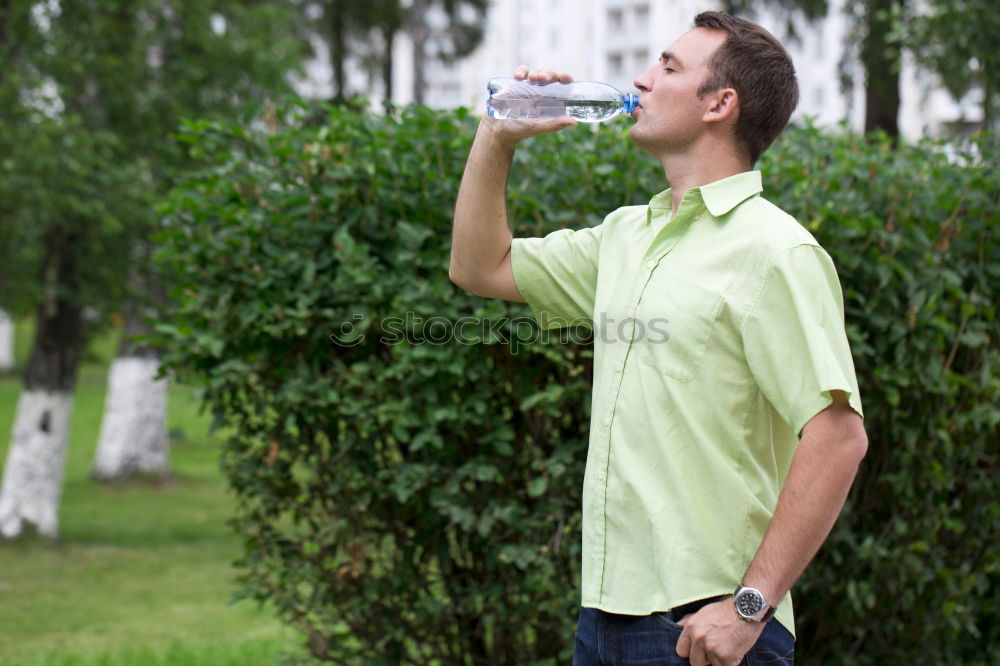 Similar – Fit young woman drinking bottled water