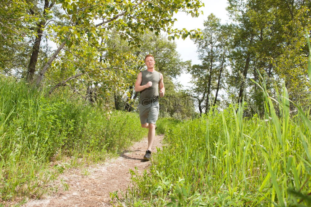 Senior Man Running in the Forest