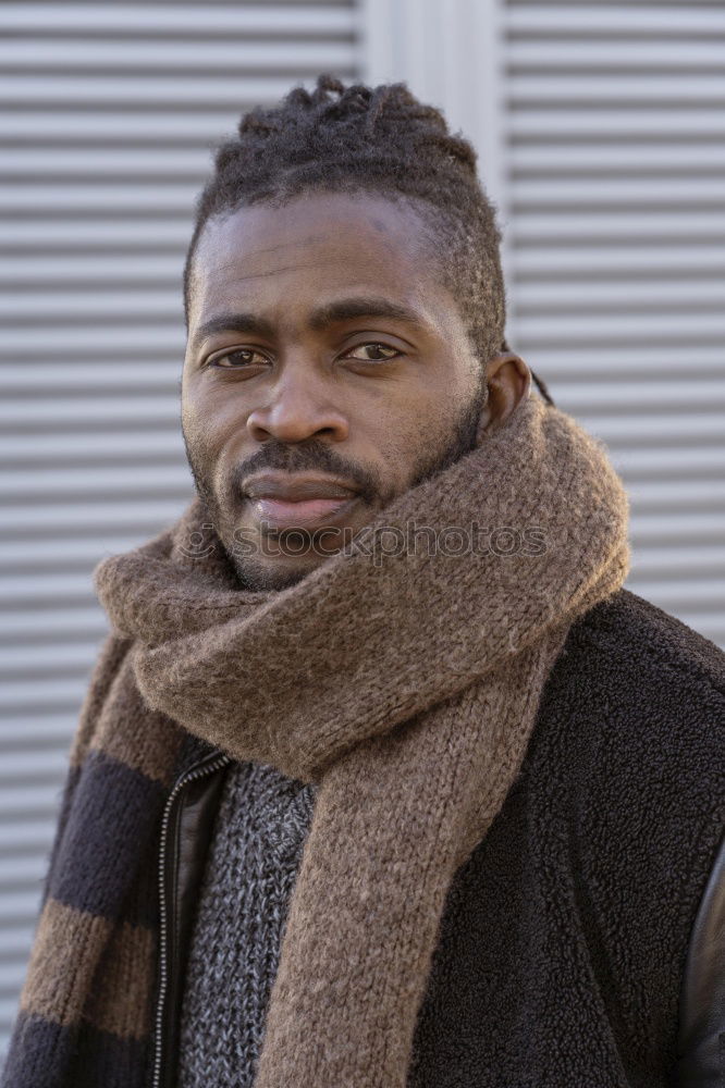 Similar – Handsome afro-american man biting his lip and looking aside in Gran via, Madrid.