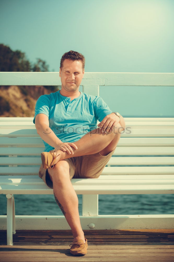 Similar – Smiling happy young man standing on a pier over the sea