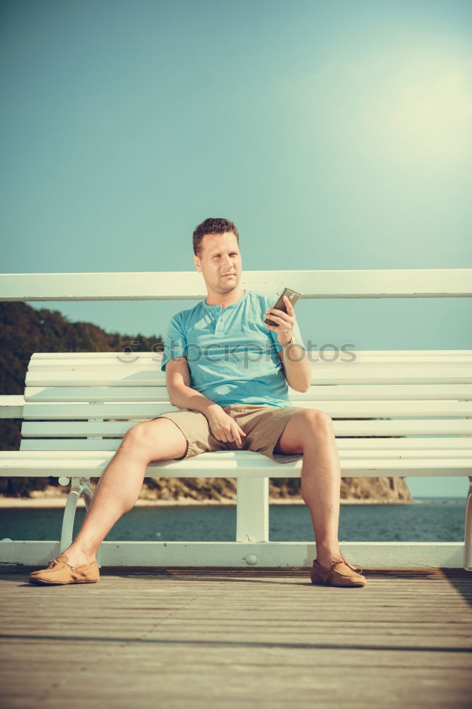 Similar – Image, Stock Photo Tourist sits on a bench on the beach