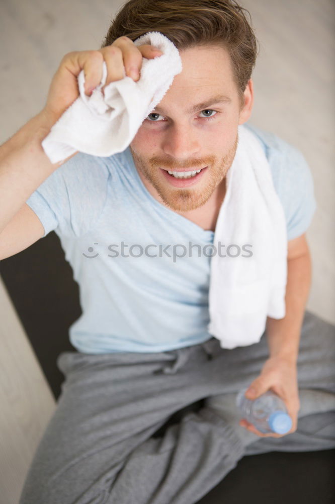 Similar – Sporty man sitting with towel and water bottle in gym floor