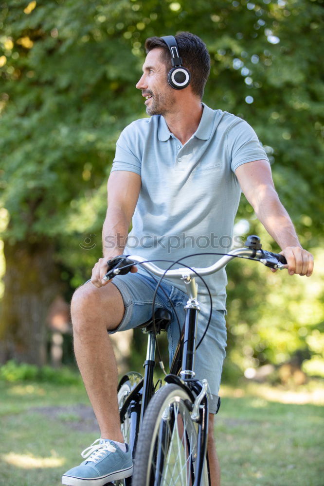 Similar – Image, Stock Photo A man pumps up the tire on his bicycle with a bicycle pump