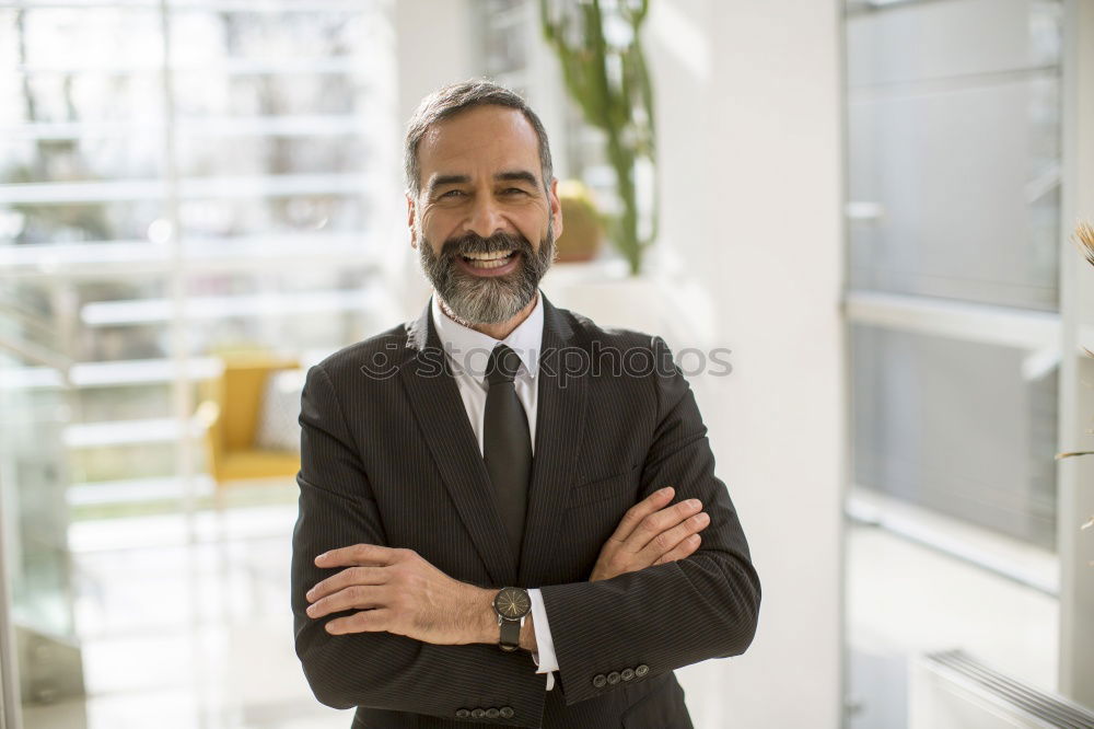 Senior businessman outside of modern office building.