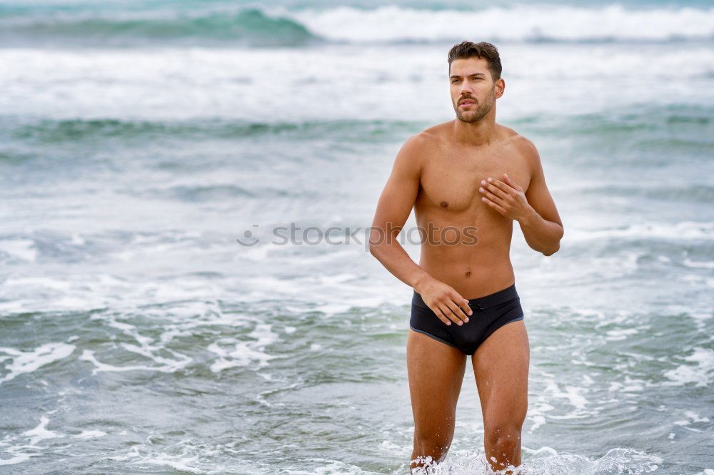 Similar – Handsome muscular man bathing on the beach