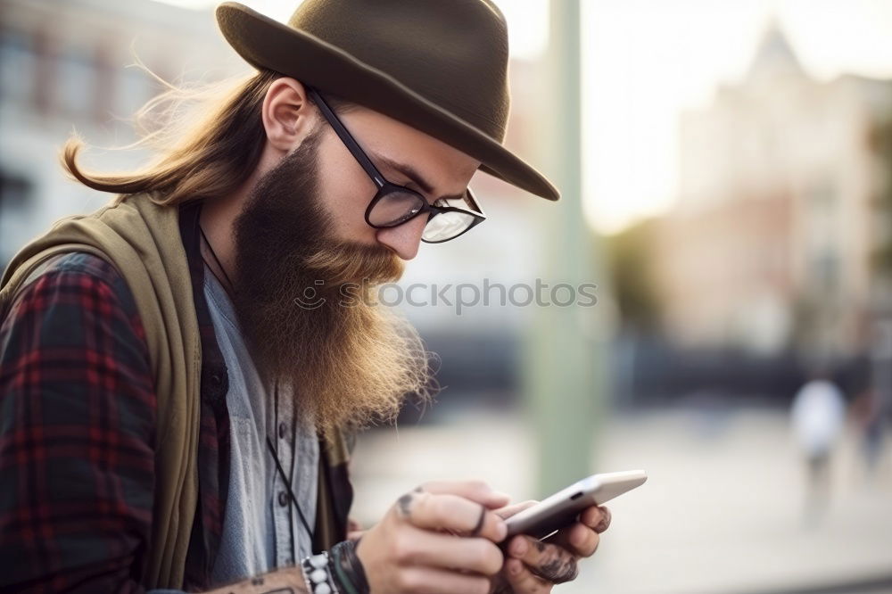 Similar – Image, Stock Photo Young smiling man looking at his smartphone in the street