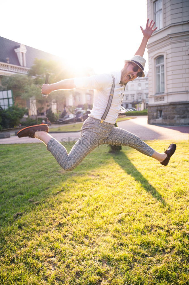 Similar – Woman jumps barefoot on blue rubber hills into the air with outstretched arms