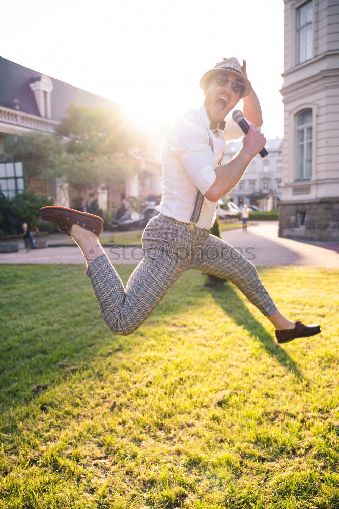 Similar – Happy man jumping wearing winter clothes in the street