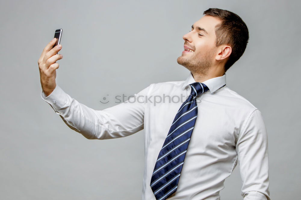 Similar – Business man with mobile phone in his hand