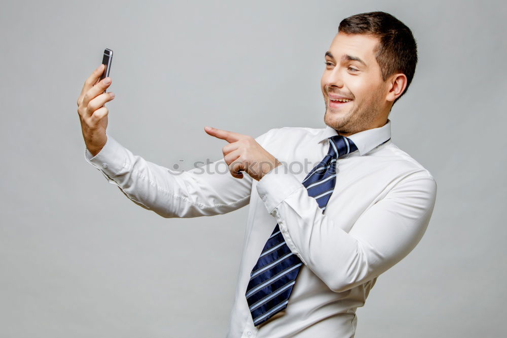 Similar – Business man with mobile phone in his hand