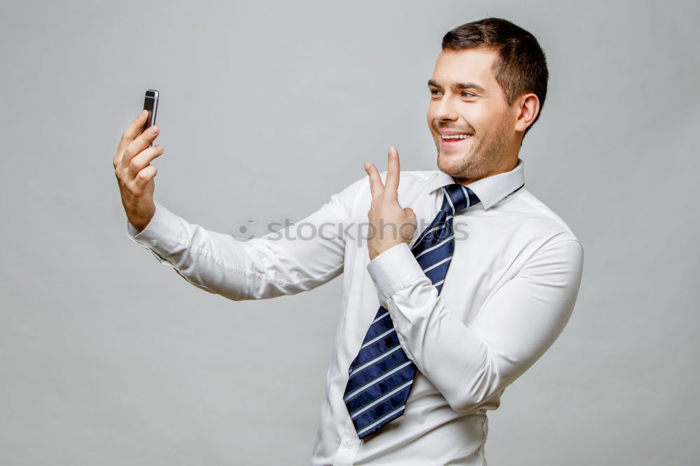 Similar – Business man with mobile phone in his hand