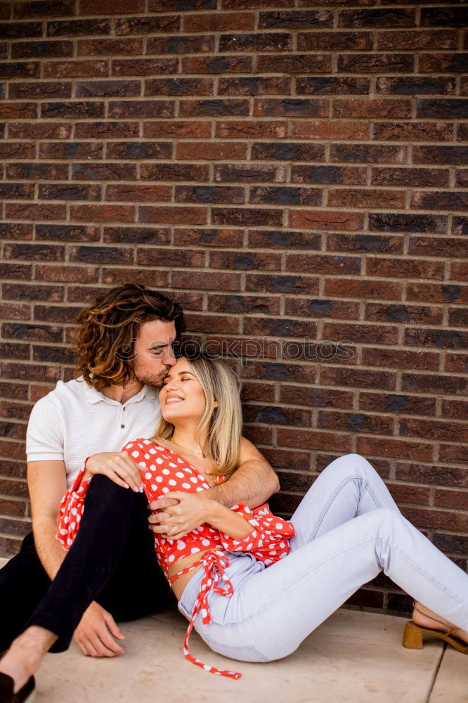 Similar – Image, Stock Photo Kissing couple at stone wall with metal decorated bars