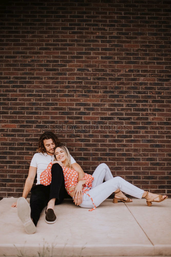 Similar – Couple embracing on evening street