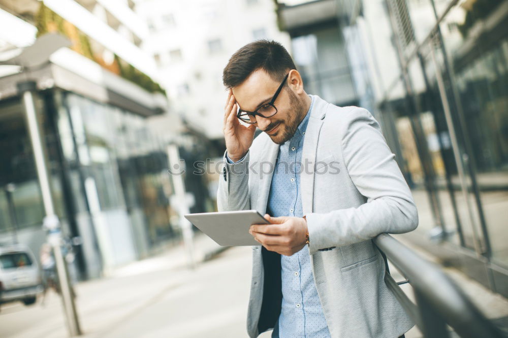 Similar – Image, Stock Photo Young smiling man looking at his smartphone in the street