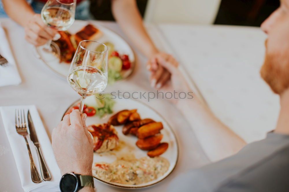 Similar – Group of People enjoying food and wine at restaurant