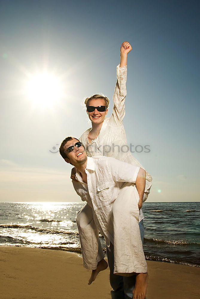 Similar – Happy family standing on the beach at the day time. People having fun outdoors. Concept of summer vacation and friendly family.