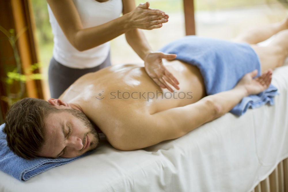 Young man having massage in spa