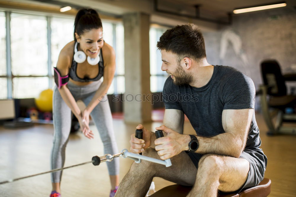 Similar – Personal trainer helping young woman lift weights