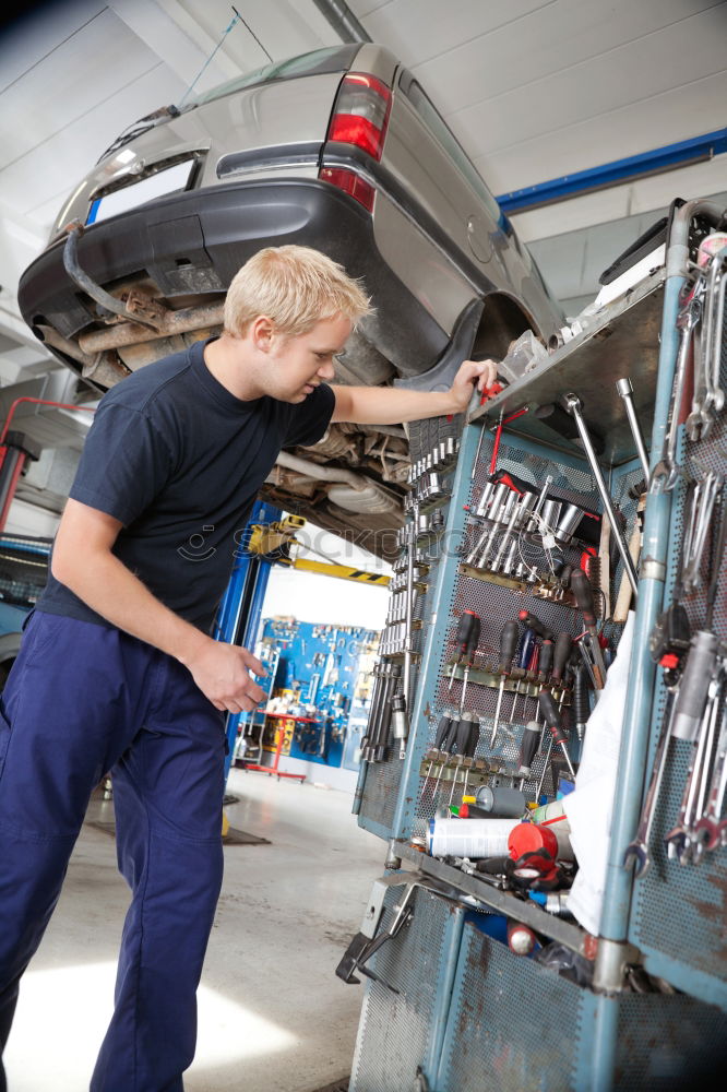 Similar – Professional Mechanic Repairing Car.