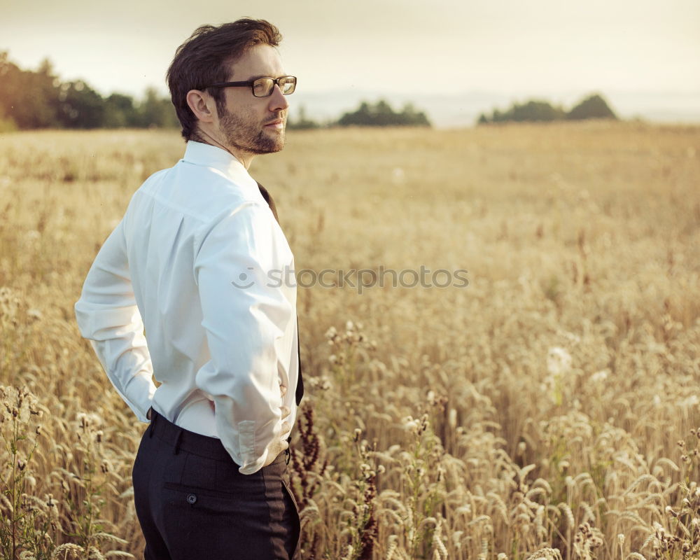 Similar – Image, Stock Photo Young man in a sunny autumn day