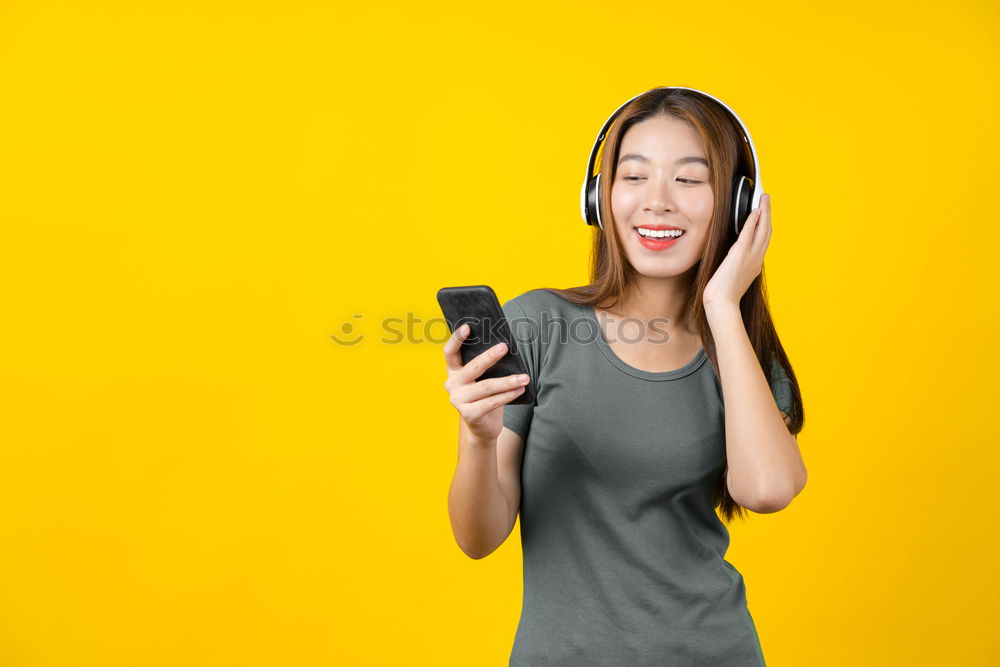 Similar – Portrait of beautiful young woman using mobile phone in the street.