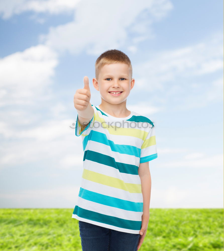 Similar – A kid holding a happy emoticon face