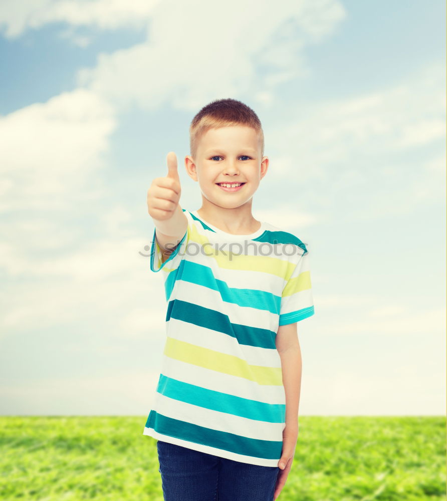 Similar – A kid holding a happy emoticon face